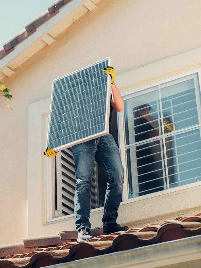 services-04 Technician carrying a solar panel on a rooftop for installation, promoting renewable energy.