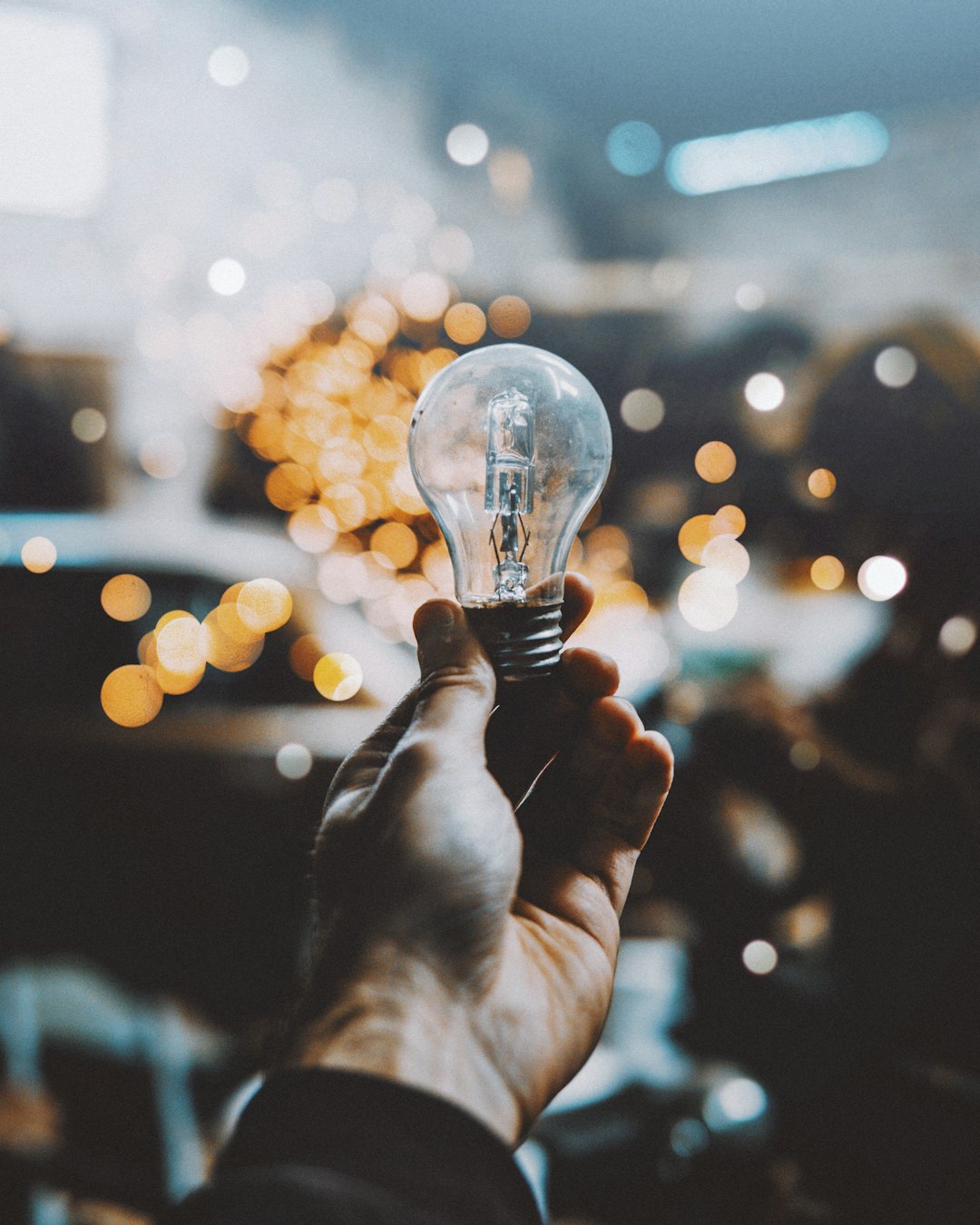 services-img a-person-holding-a-light-bulb-in-their-hand-5fsy2trcrai